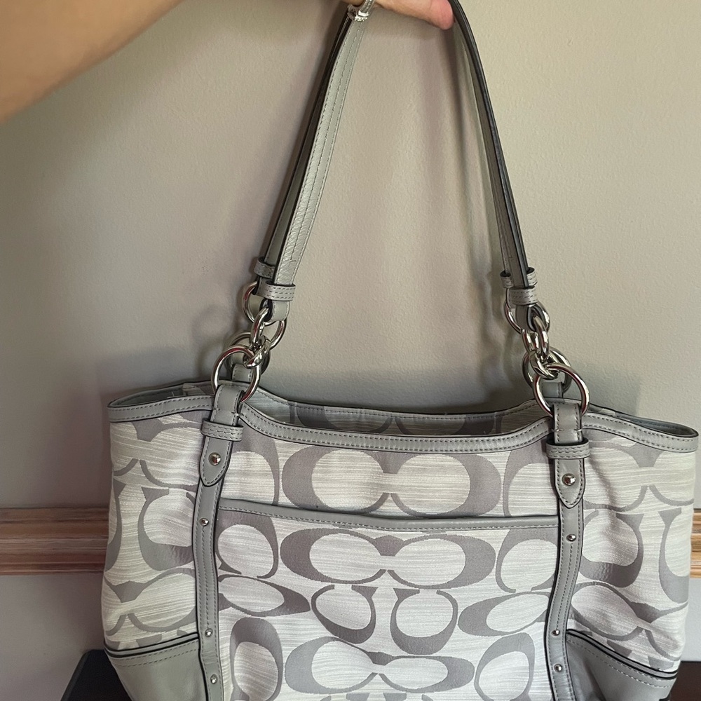 Grey Coach purse NWOT. Beautiful pink lining and pocket in front.